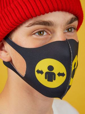Profie of person wearing a red hat and a black face mask with the yellow Please give me space symbol