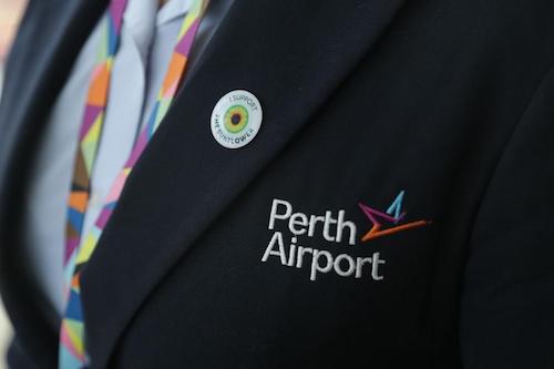 A jacket with Perth Airport logo on and the Hidden Disabilities Sunflower logo