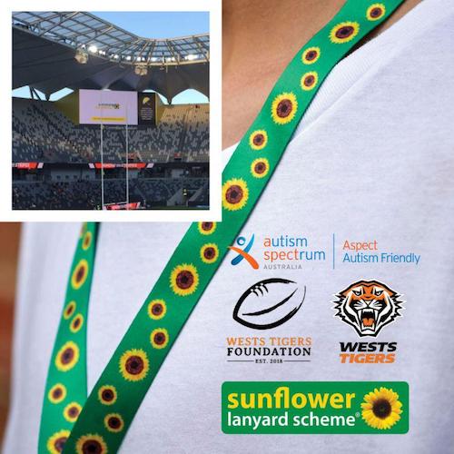 The West Tigers screen showing the Hidden Disabilities advert. This image is overlaid on an image of a dual branded T-shirt with a Sunflower lanyard. 