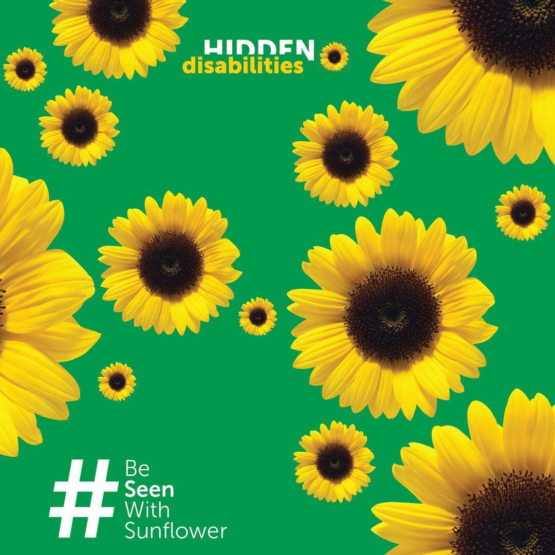Green background with yellow sunflowers, the Hidden Disabilities Sunflower logo and #BeSeenWithSunflower